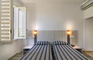 Postel nebo postele na pokoji v ubytování Hotel Apuana