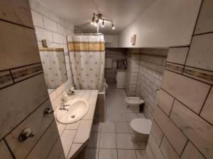 a bathroom with two toilets and a sink at Basement Apartment in Cologne