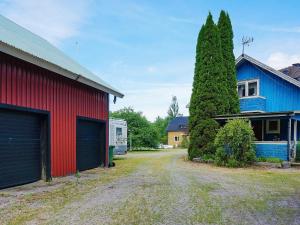 a yard with two garage doors and a house at 6 person holiday home in MARIESTAD in Mariestad