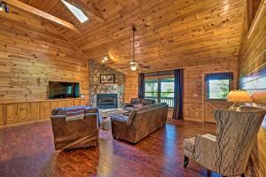 a living room with a couch and chairs and a television at Cozy Sunset View Cabin with Game Room and Mtn Views! in Ellijay