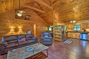 a living room with a couch and a table in a cabin at Cozy Sunset View Cabin with Game Room and Mtn Views! in Ellijay