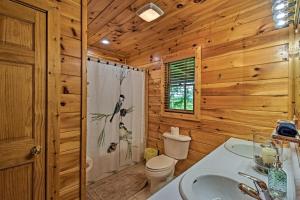 a bathroom with a toilet and a sink at Cozy Sunset View Cabin with Game Room and Mtn Views! in Ellijay +35 photos