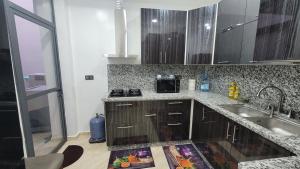 a kitchen with a sink and a counter top at ZR Comfort in Fez