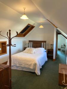 a bedroom with a large bed with white sheets at Taiparoro House in Tauranga