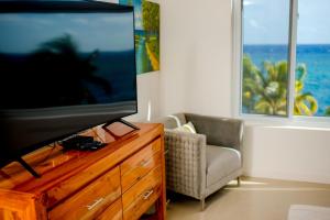 TV a/nebo společenská místnost v ubytování Whispering Seas Oceanfront Suite