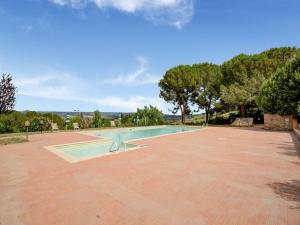 a swimming pool on a brick patio with trees and a blue sky at Varna Charm Tuscan Getaway in Querce +32 photos
