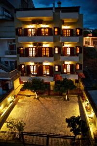 a large apartment building with a courtyard at night at Anastasiadis House in Neos Marmaras