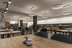 a dining room with tables and chairs and a cafeteria at Hotel Alexander in Krakow +37 photos