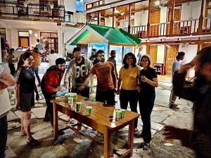 a group of people standing around a picnic table at Jungle by sturmfrei Manali in Manāli