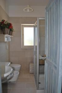 マルティナ・フランカにあるLa Vitosaのバスルーム(トイレ2つ、洗面台、窓付)