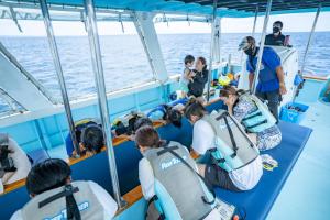 a group of people sitting on a boat at Hotel Monterey Okinawa Spa & Resort in Onna