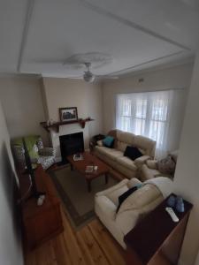 a living room with a couch and a table at Pink Gums Farmstay in Currency Creek