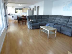 a living room with a couch and a table at Riverfront Holiday House in Wellington East