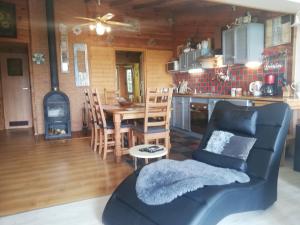 a living room with a couch and a table and a kitchen at Villa Beata in Nowe Warpno