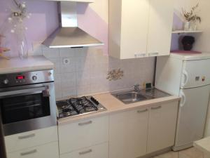 a kitchen with a sink and a stove top oven at Apartment MeliRa in Novi Vinodolski