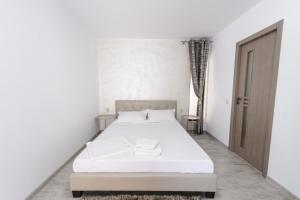 Postel nebo postele na pokoji v ubytování Toma Residence