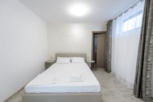 Postel nebo postele na pokoji v ubytování Toma Residence