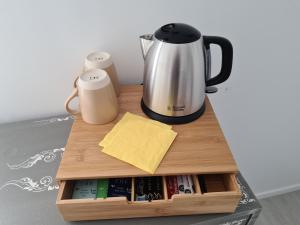 a cutting board with a coffee maker on a table at Le Petit Chêne in Orgnac-lʼAven
