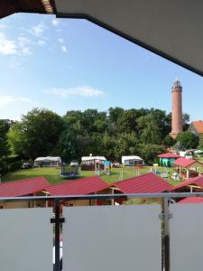 a view from a window of a park with a lighthouse at Apartament Latarnik- Yellow in Gąski