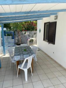 a table and chairs sitting on a patio at Quirino Residence in Gaeta