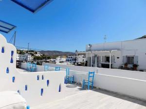 a group of blue chairs sitting on a roof at Yacht Front Studio - No 3 in Ios Chora