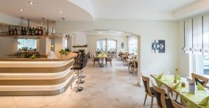 a restaurant with a bar and some tables and chairs at Landhotel Kristall in Bad Marienberg