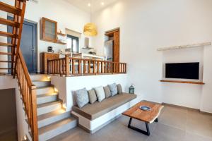 a living room with a couch and a table at Cato Agro 2, Seafront Villa with Private Pool in Karpathos