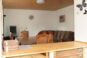 a living room with a table and a couch at Apartmán Nelinka in Rudná pod Pradědem