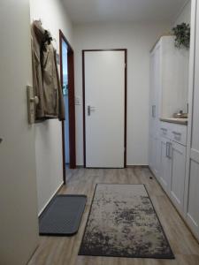 a hallway with a door and a rug in a room at Harz im Herzen in Altenau