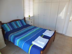 a bedroom with a bed with towels on it at Cyking Apartment 103 postcode 8046 in Paphos