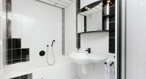 a white bathroom with a sink and a shower at Landhaus Dorothee in Meisburg