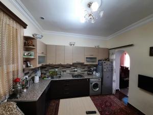 a kitchen with a sink and a stove top oven at Ararat B&B in Chʼiva