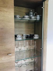 a bunch of wine glasses in a glass cabinet at Riverside Habovka in Habovka