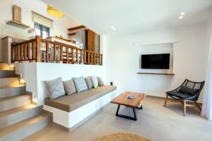 a living room with a couch and a table at Cato Agro 5, Seafront Villa with Private Pool in Karpathos