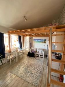 a living room with a loft bed and a table at INFINITY Blue 3 in Burgas