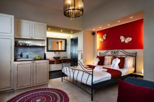 a bedroom with a bed with a red wall at Zimmer & Spa Kesem Hamaga in Bet Leẖem HaGelilit