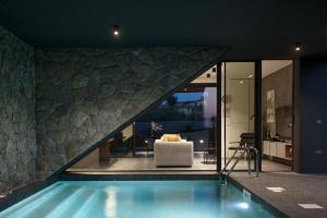 a house with a swimming pool and a living room at Koralle Mugeba in Mugeba