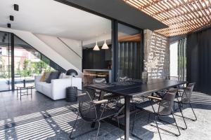 a dining room with a black table and chairs at Koralle Mugeba in Mugeba +33 photos