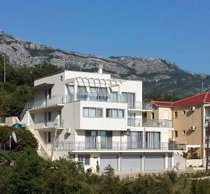 a large white building on top of a hill at Villa Blanca in Petrovac na Moru
