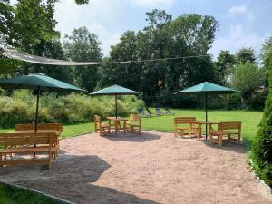 a group of tables and chairs with umbrellas at Stayhome Tossens in Butjadingen