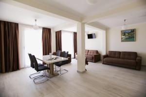 a living room with a table and chairs and a couch at Villa Blanca in Petrovac na Moru