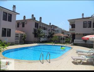 a large swimming pool in front of some buildings at PEACEFUL HOUSE in Fethiye +13 photos