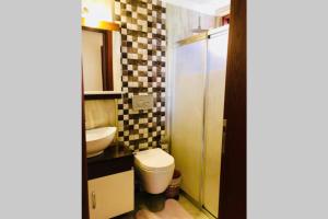 a bathroom with a toilet and a sink at PEACEFUL HOUSE in Fethiye