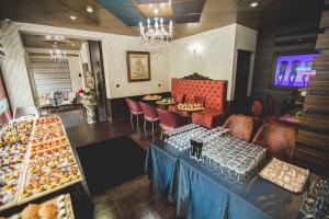 a restaurant with a table and chairs and a buffet at aSa Boutique Hotel in Haskovo