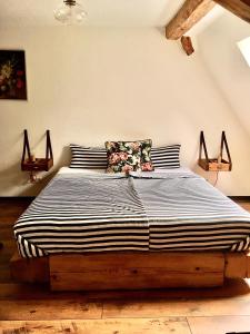 a bedroom with a large bed with black and white stripes at Ferienwohnung Kunst und Kulturschuppen Hasenmühle in Kammerstein