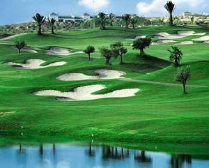 a group of golf greens with water in the foreground at Vistabella in Orihuela