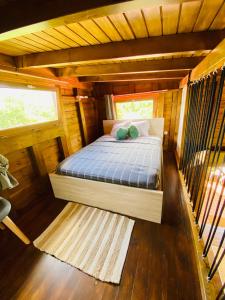 a bedroom in a log cabin with a bed at Banana Cottage Ecolodge & Spa in Le Gosier