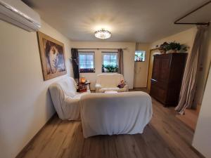 a living room with two white chairs and a table at Holiday Home IRENE in Lilo