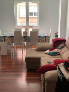 a living room with a couch and a table and chairs at Apartamento en Boiro in Boiro