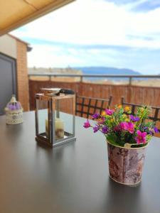 a table with a vase of flowers and a candle at ACOGEDOR ÁTICO DÚPLEX EN TREMP in Tremp +46 photos